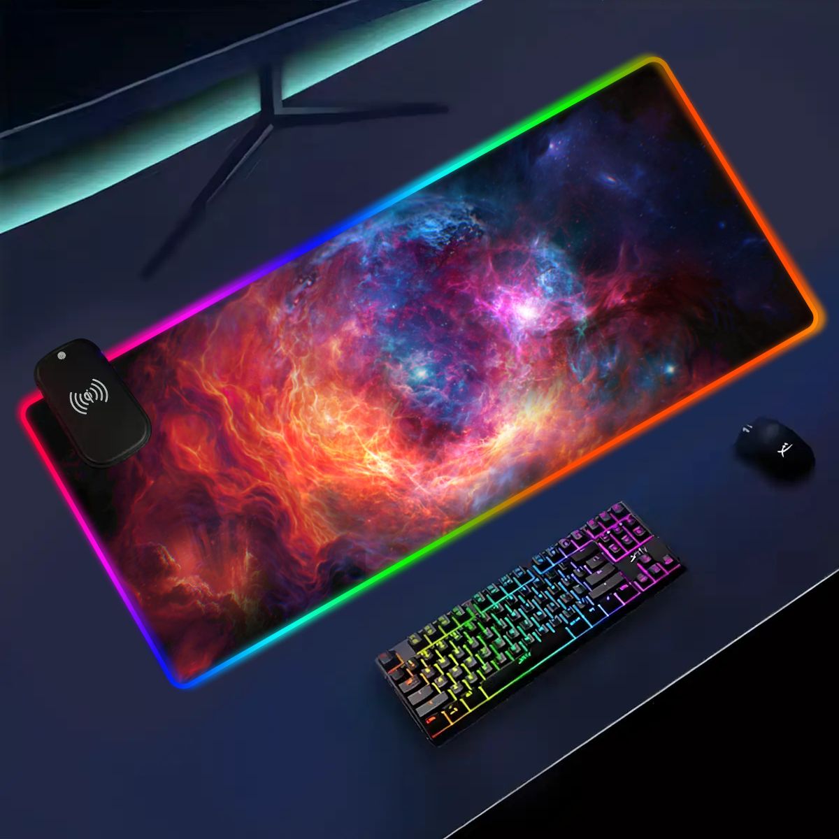 Angled dark desk setup with The Cradle RGB deskmat, wireless charging module, keyboard, and mouse.