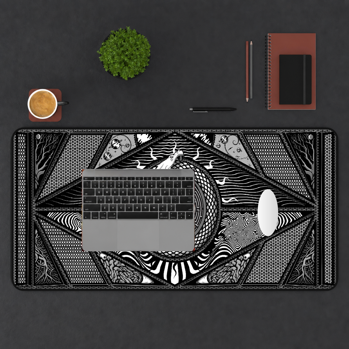 Ouroboros printed mat in a top-down workspace.